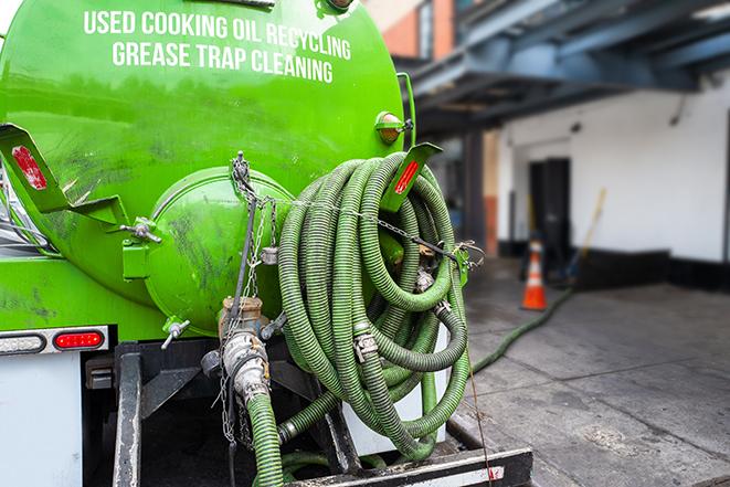 heavy-duty vacuum truck pumping out a grease trap in East Los Angeles CA